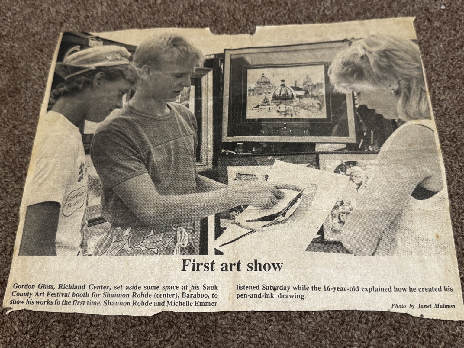 1986 newspaper clipping titled First art show, showing 16-year-old Shannan Rohde presenting a pen-and-ink drawing at the Sauk County Art Festival