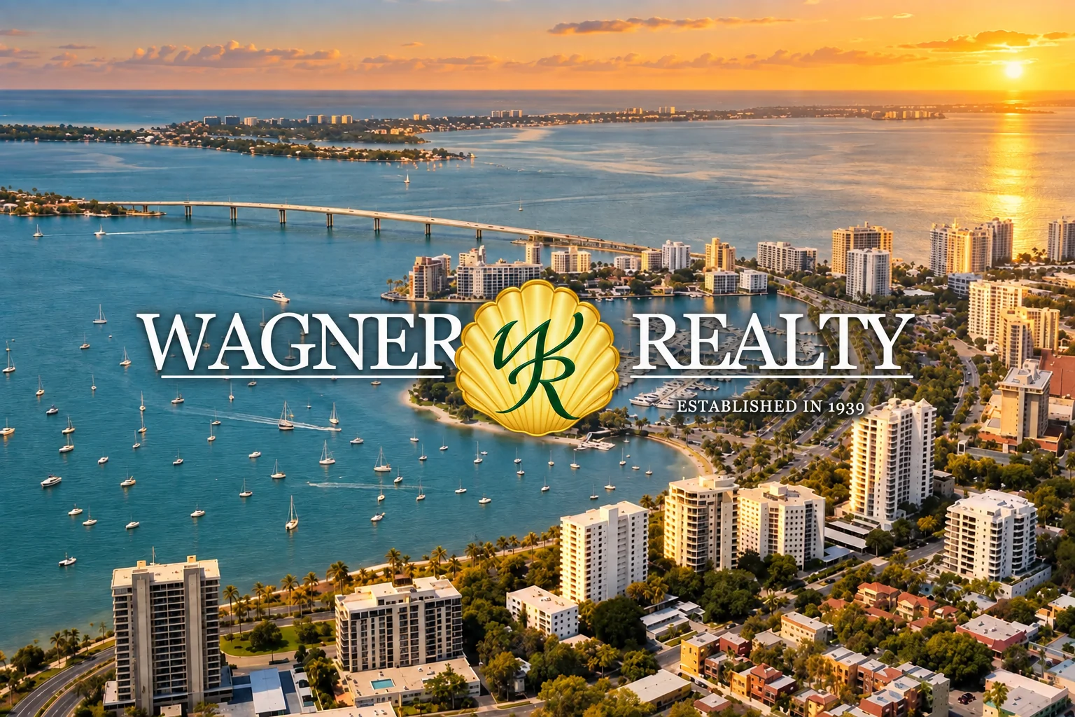 Wagner Realty logo with a soft shadow directly over a golden-hour Sarasota Bay aerial visualization