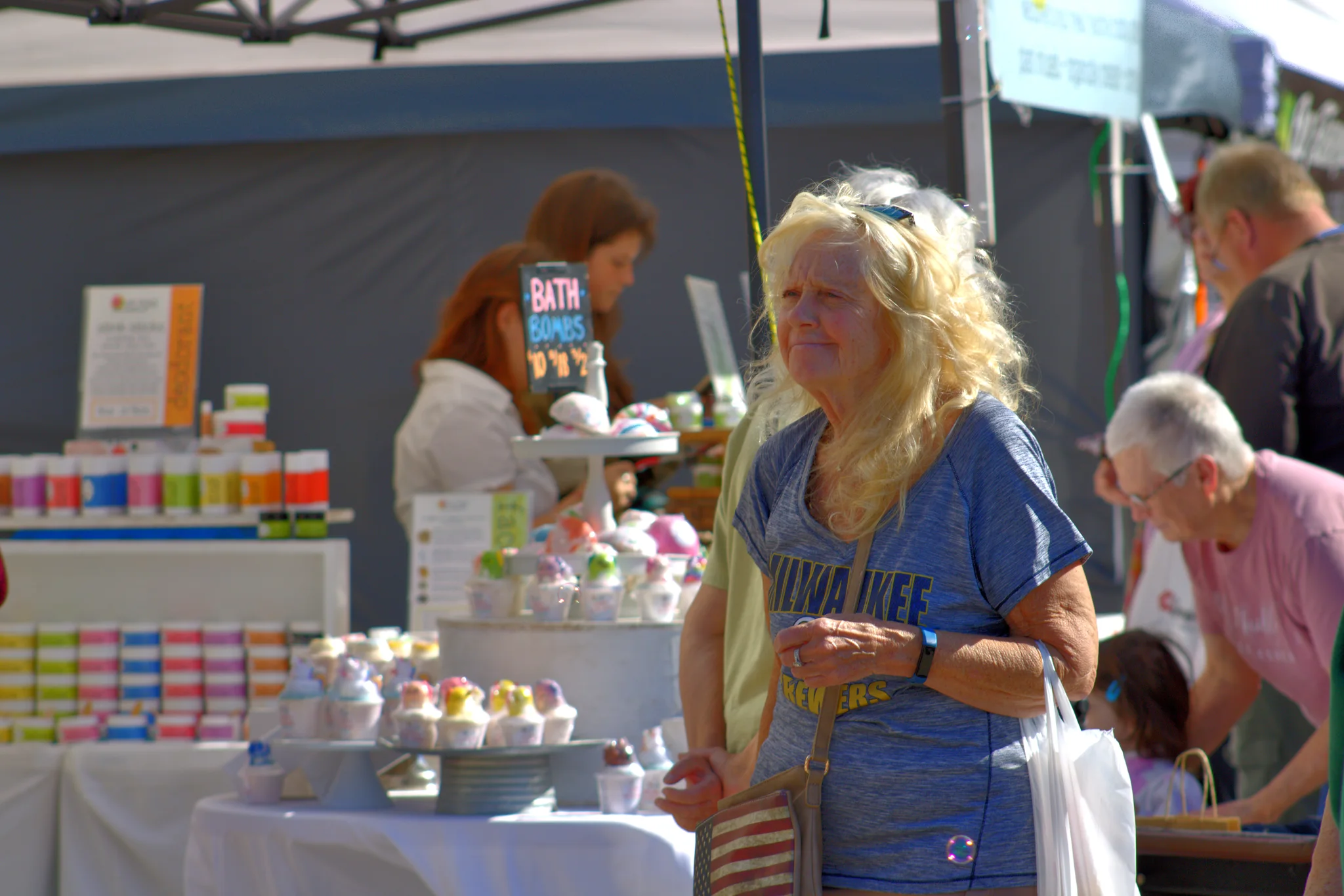 Visitor browsing food and handmade goods at a fair booth at Baraboo's 2026 Fall Fair on the Square