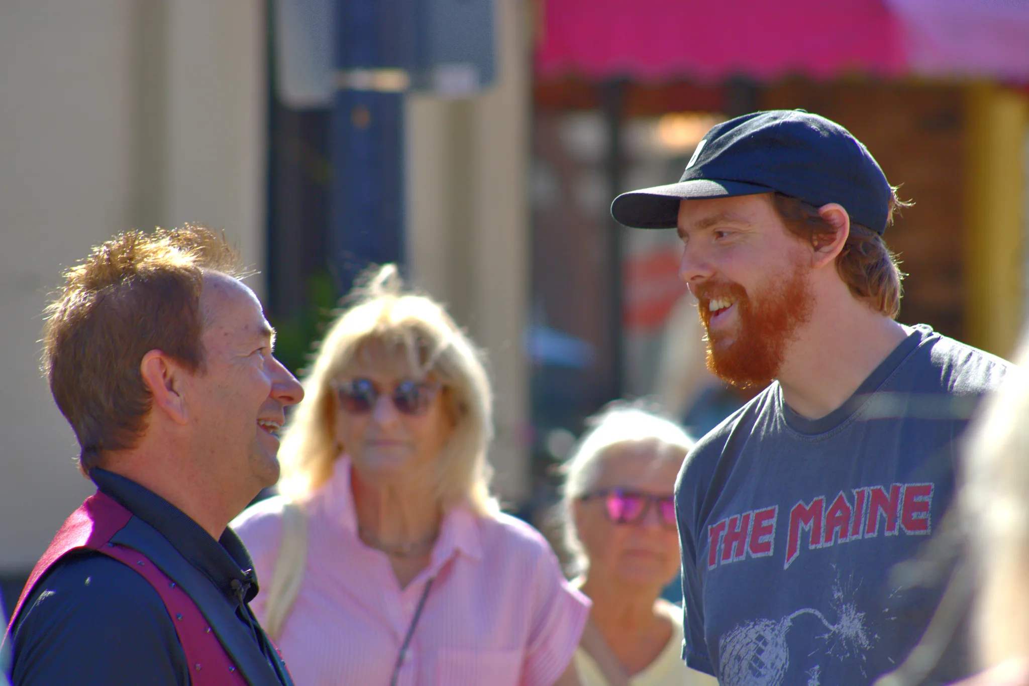Two men smiling as they talk in the fair crowd at Baraboo's 2026 Fall Fair on the Square
