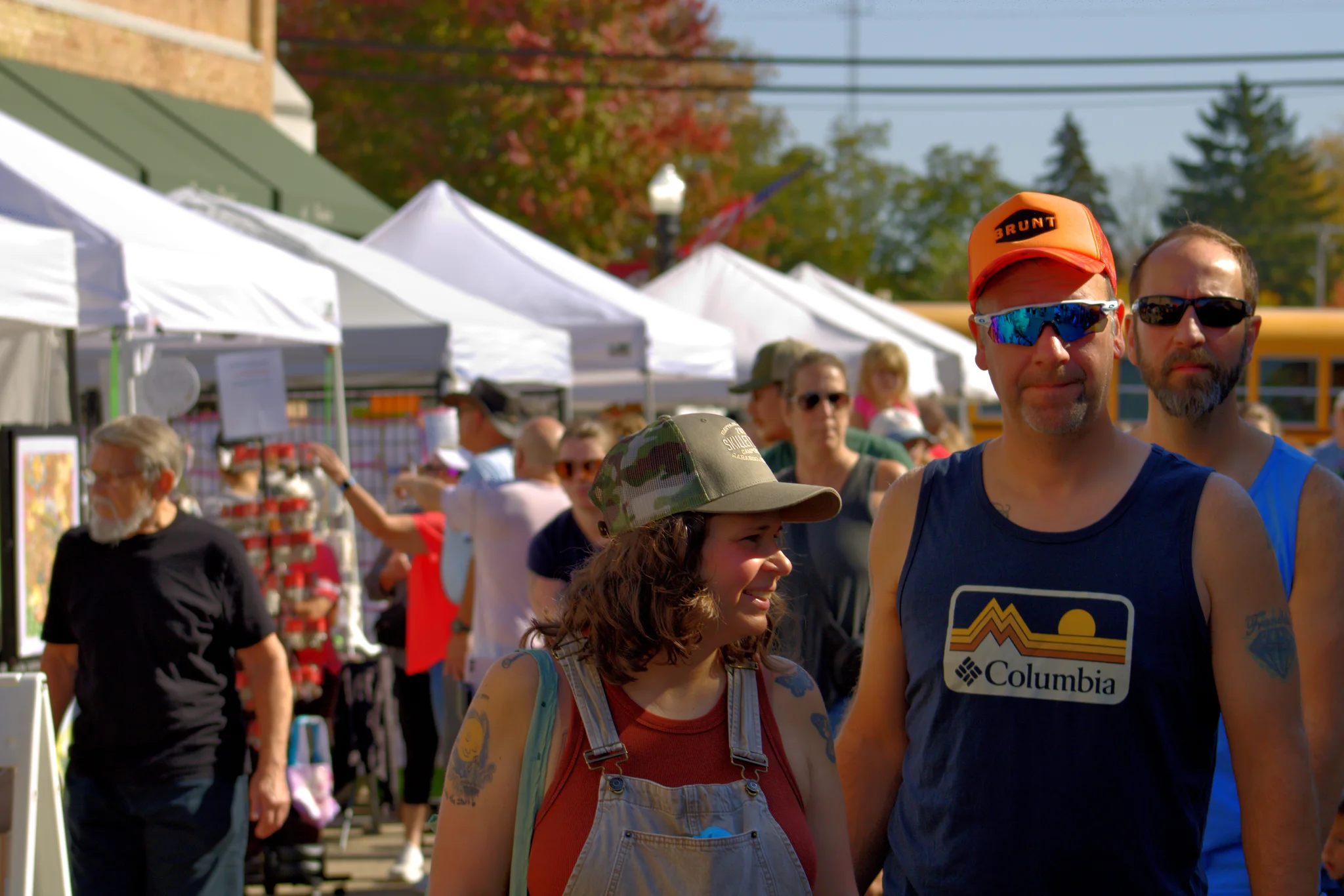 Visitors walking together between the fair tents at Baraboo's 2026 Fall Fair on the Square
