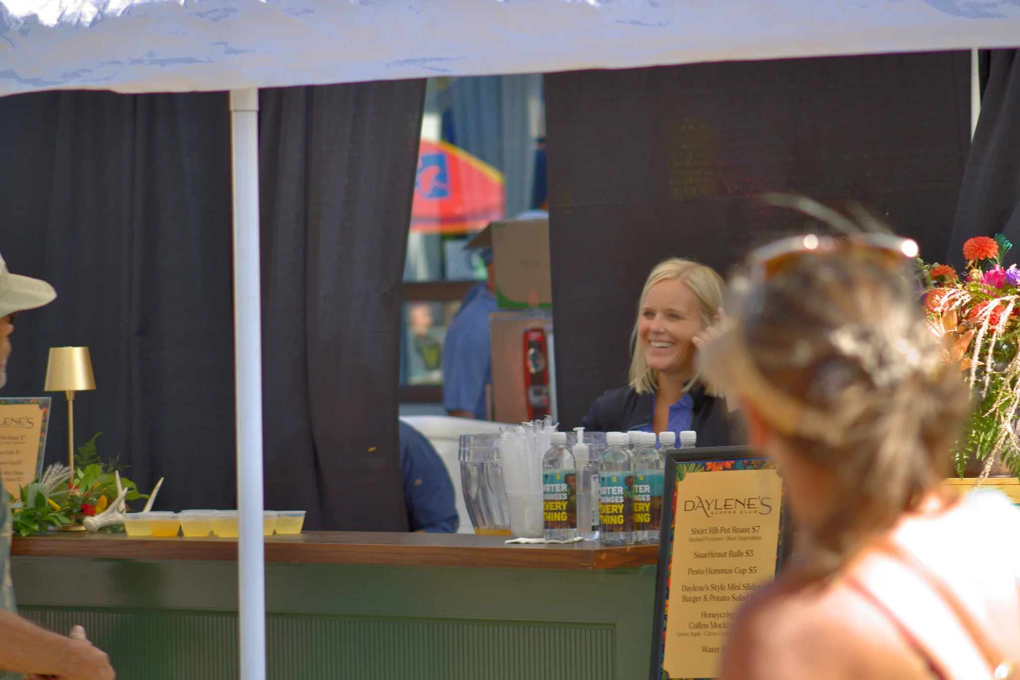 Smiling vendor greeting a customer at her booth at Baraboo's 2026 Fall Fair on the Square