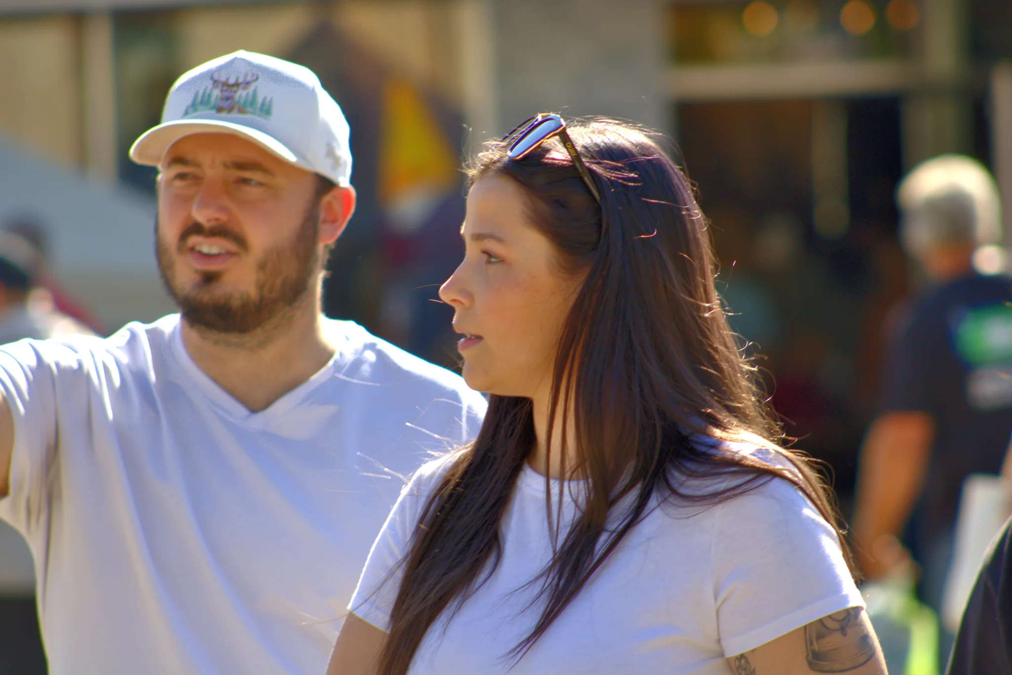 Two visitors looking toward activity on the square at Baraboo's 2026 Fall Fair on the Square