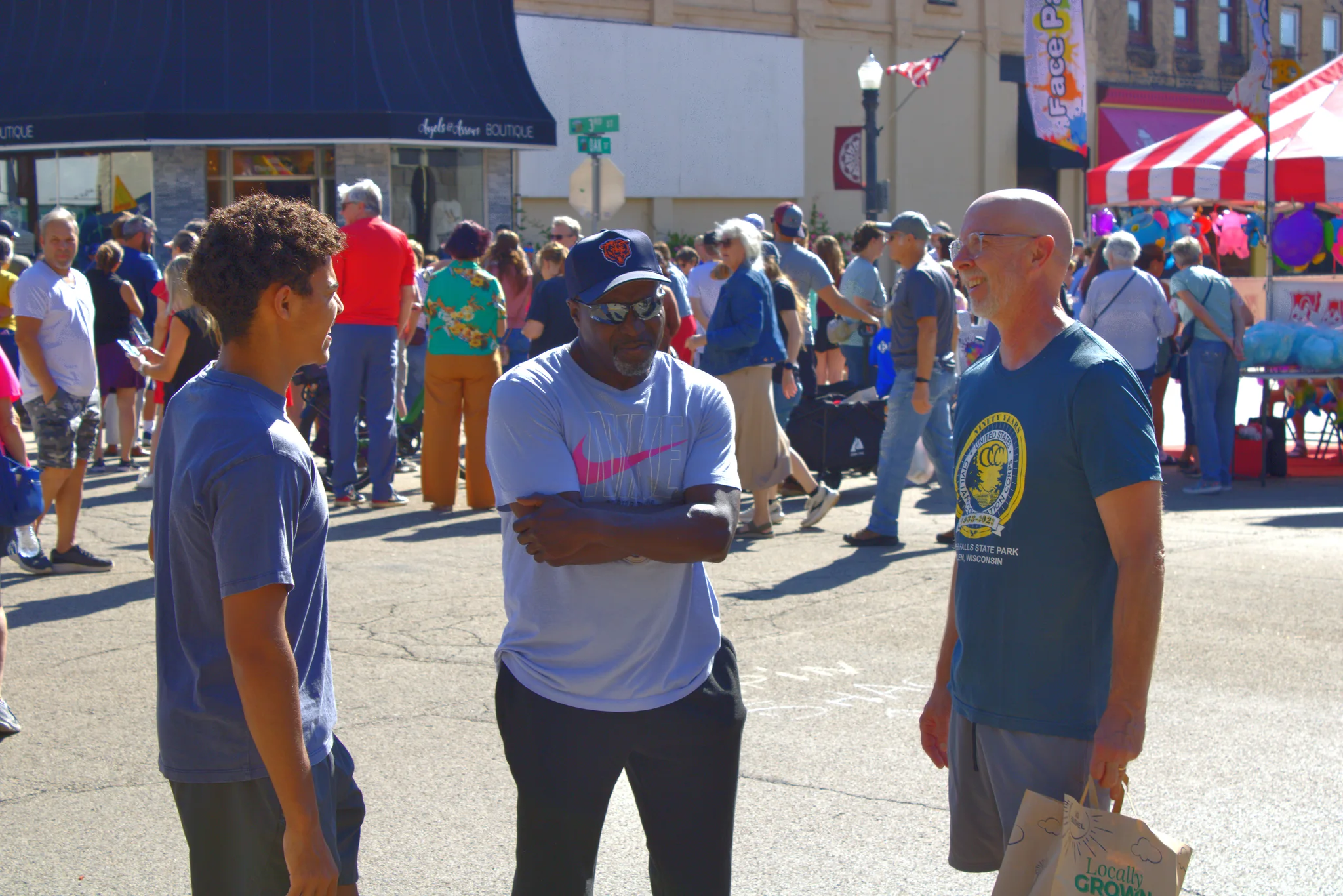 Three visitors talking amid the fair crowd at Baraboo's 2026 Fall Fair on the Square