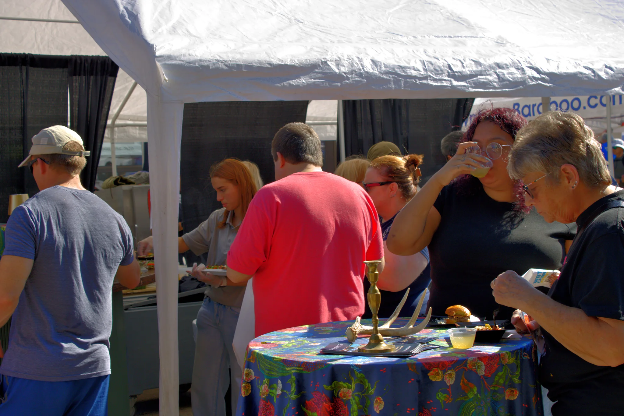 Visitors browsing a colorful table of handmade goods at Baraboo's 2026 Fall Fair on the Square