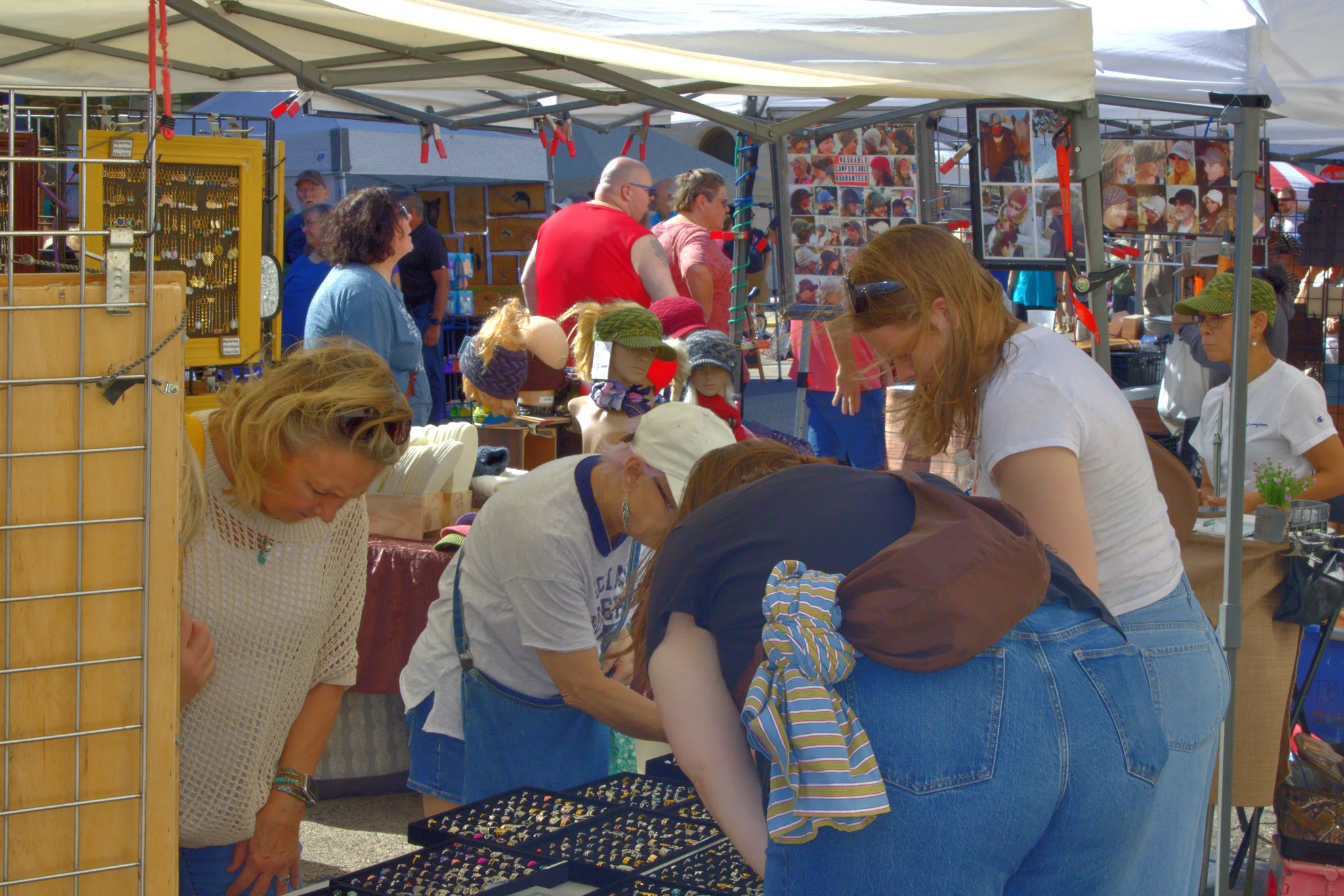 Shoppers examining jewelry inside a vendor tent at Baraboo's 2026 Fall Fair on the Square