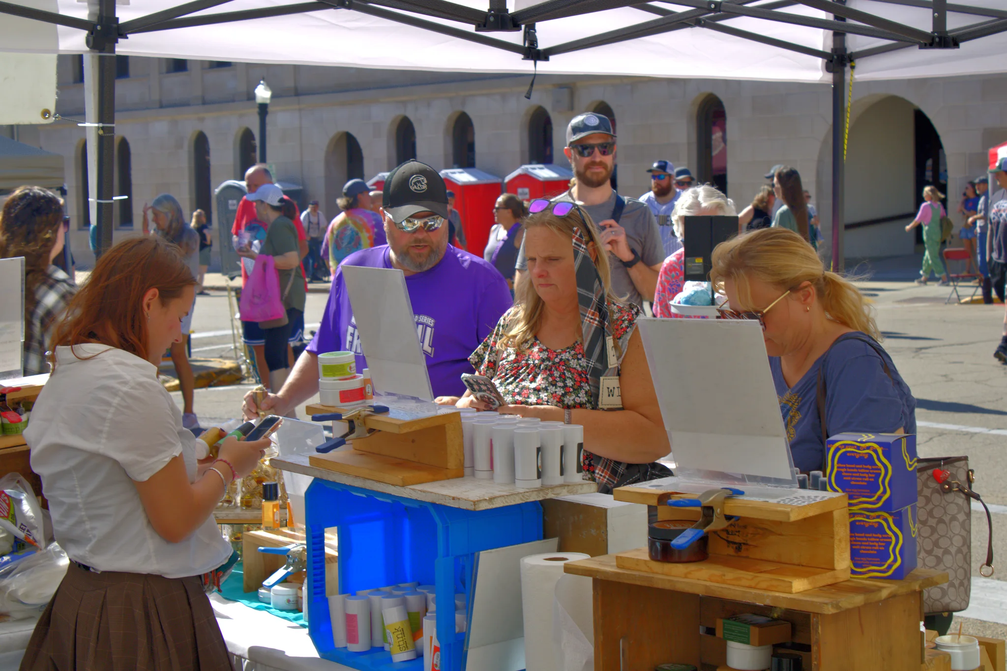 Customers talking with makers at a busy booth at Baraboo's 2026 Fall Fair on the Square