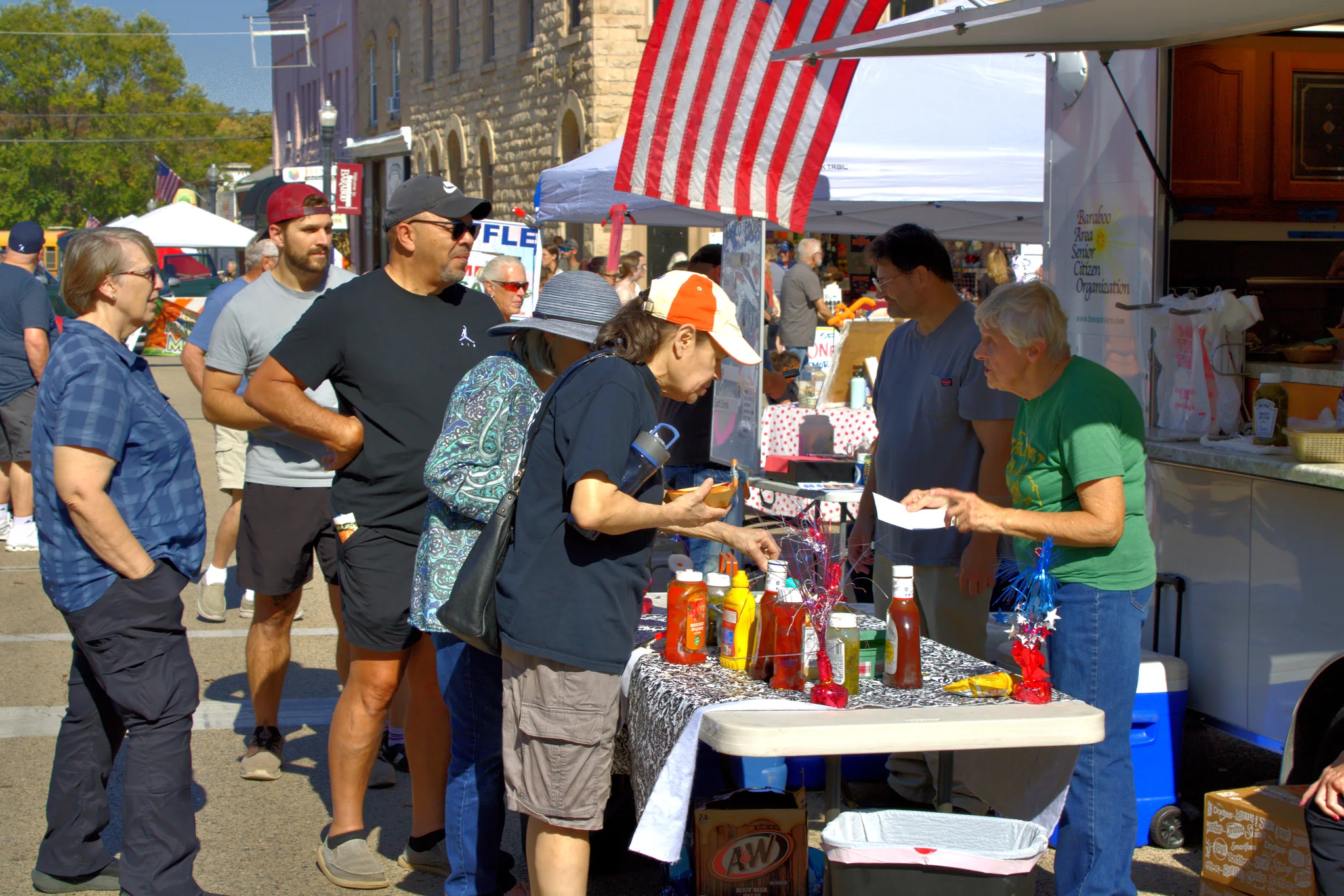 Visitors gathered around a food vendor's counter at Baraboo's 2026 Fall Fair on the Square