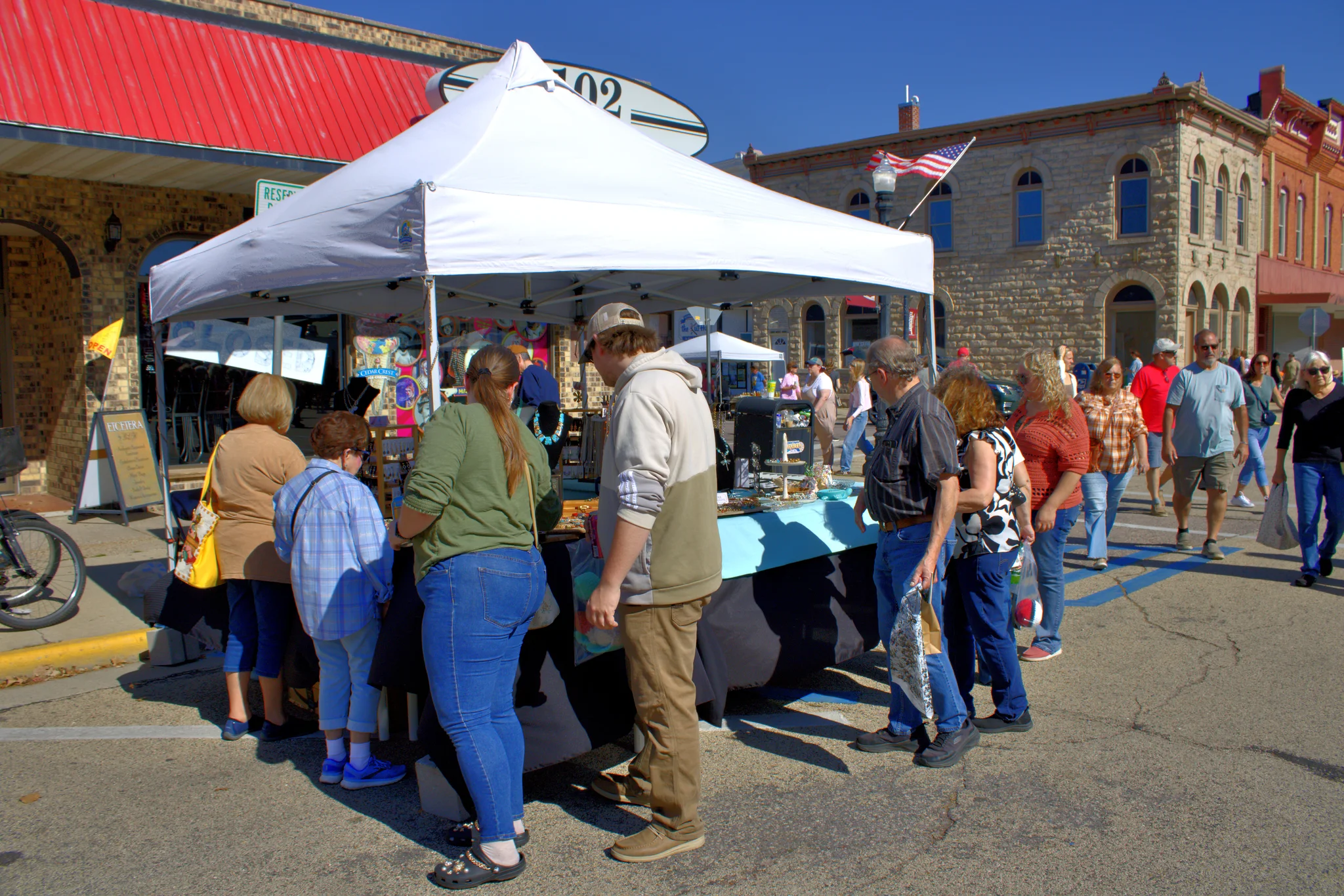 Shoppers browsing art and craft tents along the street at Baraboo's 2026 Fall Fair on the Square