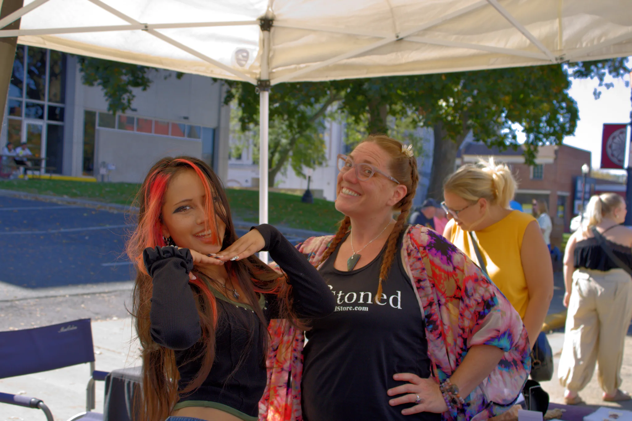Two women smiling together at a fair booth at Baraboo's 2026 Fall Fair on the Square
