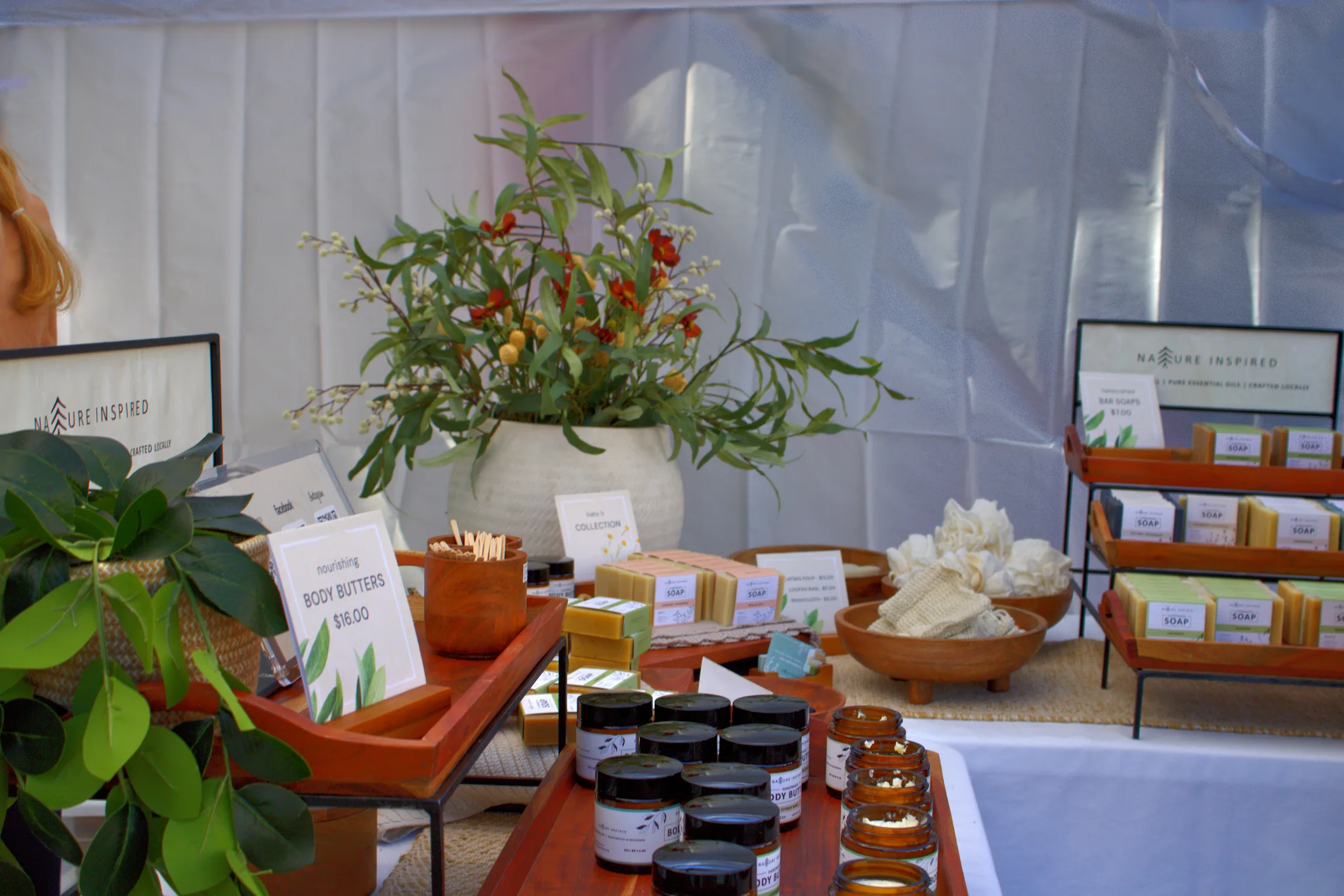 Plants and packaged goods arranged beneath a white canopy at Baraboo's 2026 Fall Fair on the Square