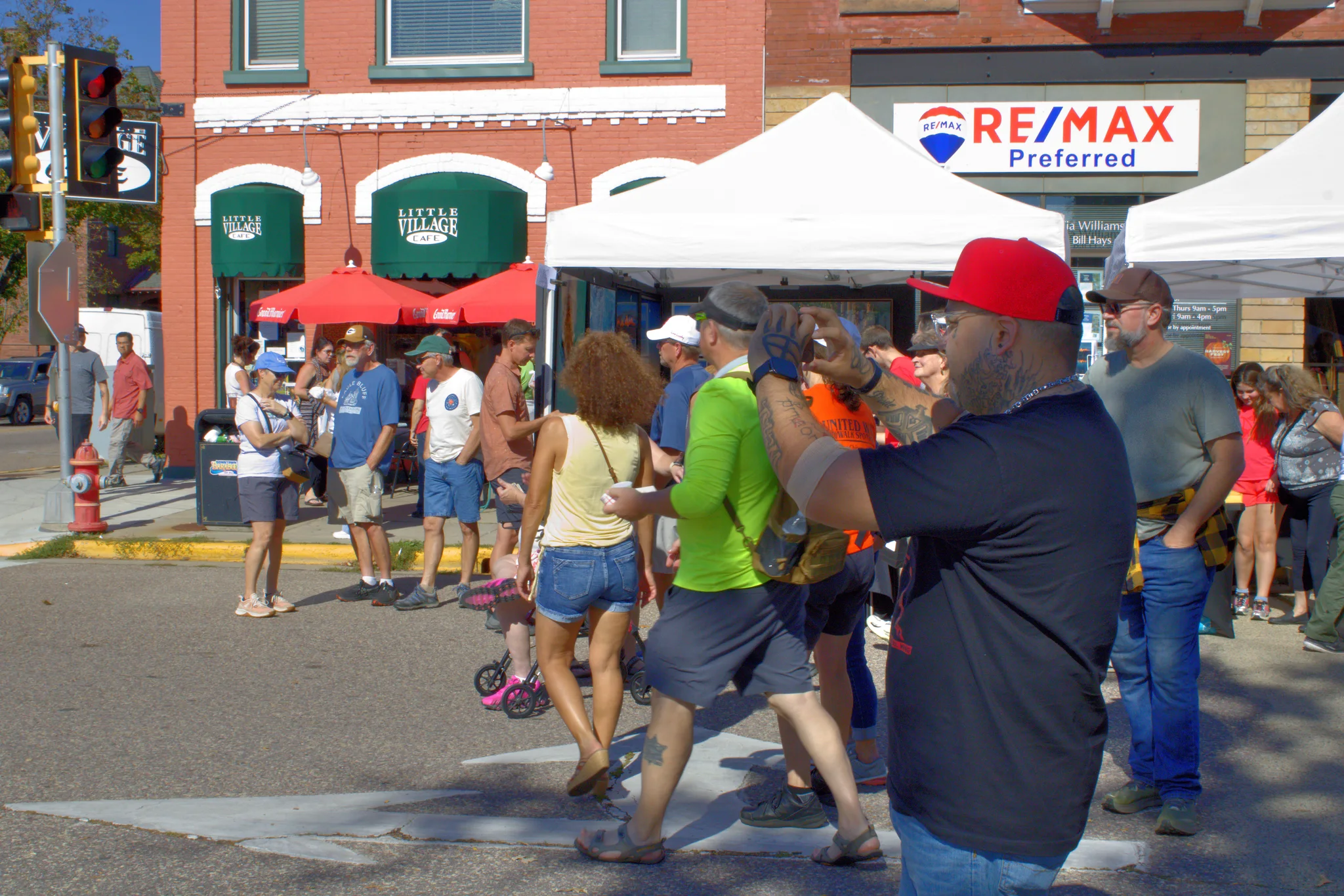 Visitors moving between tents at a downtown intersection at Baraboo's 2026 Fall Fair on the Square