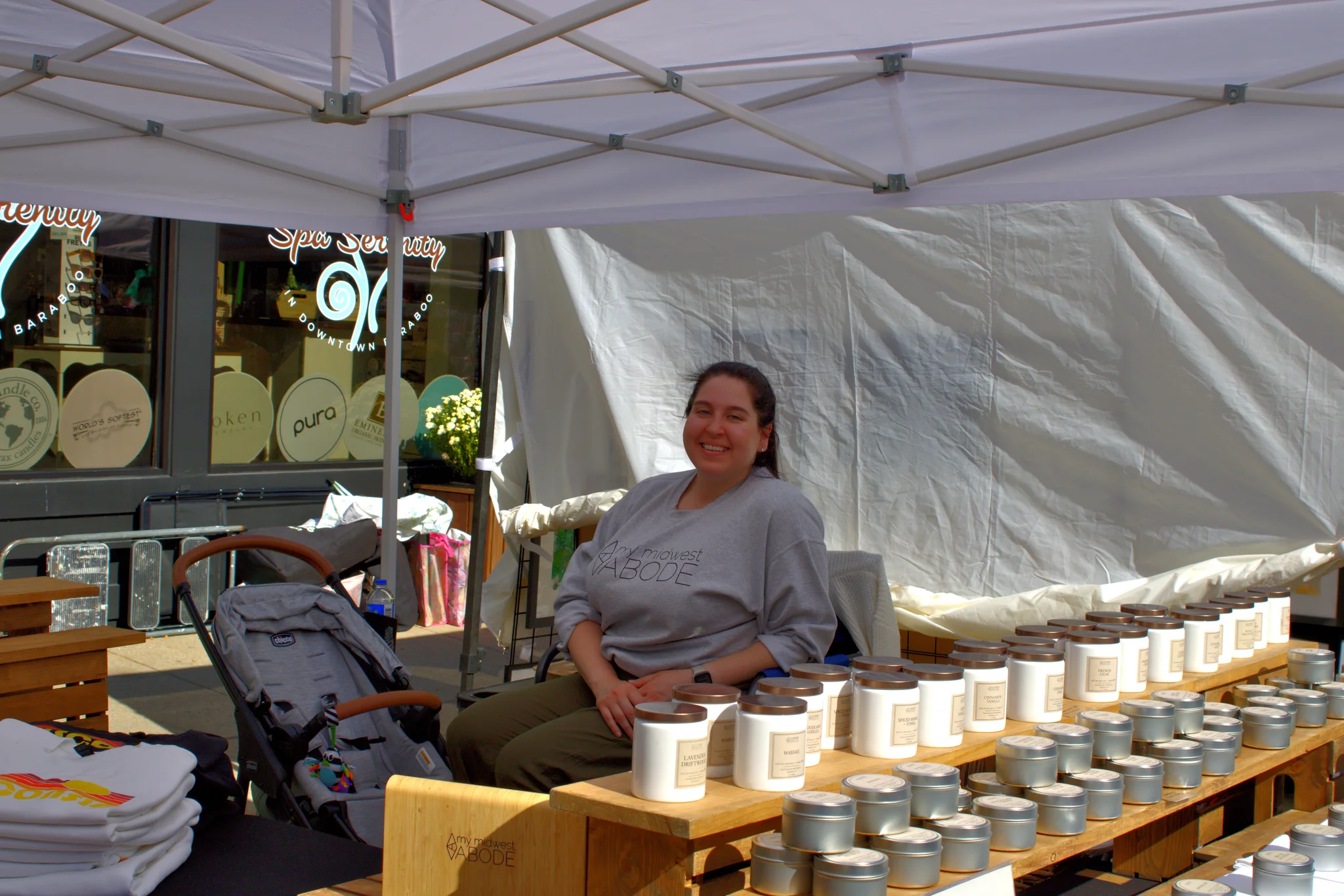 Smiling maker seated behind a display of small goods at Baraboo's 2026 Fall Fair on the Square