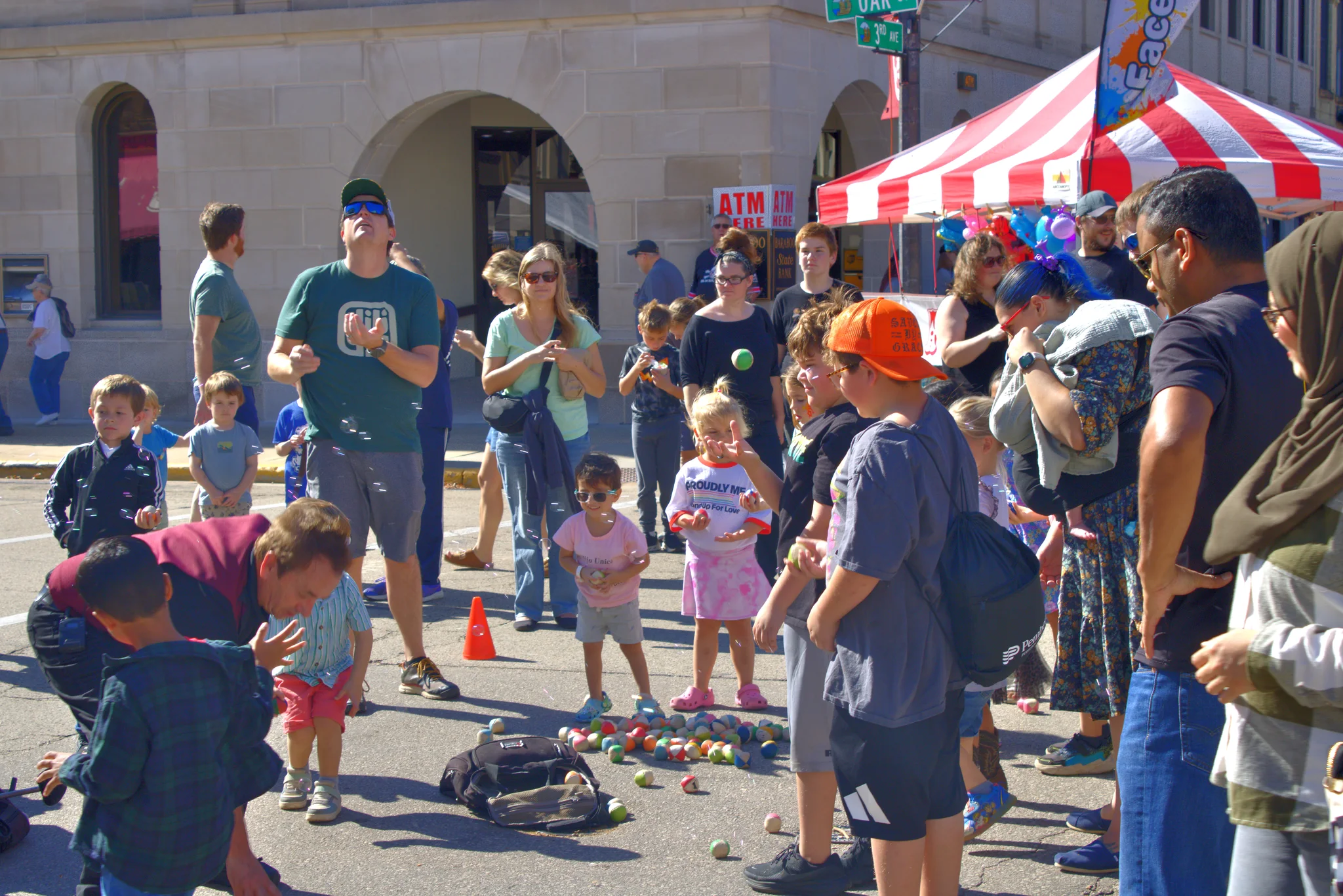 Children and families watching a street activity at the fair at Baraboo's 2026 Fall Fair on the Square