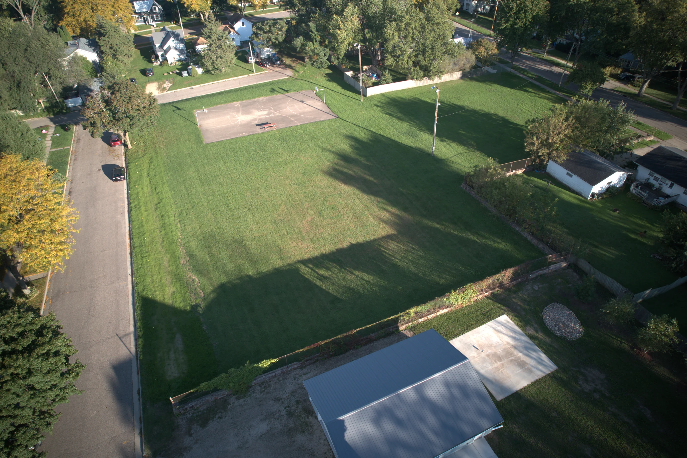 Original drone photograph of Weber Park's open field and basketball court
