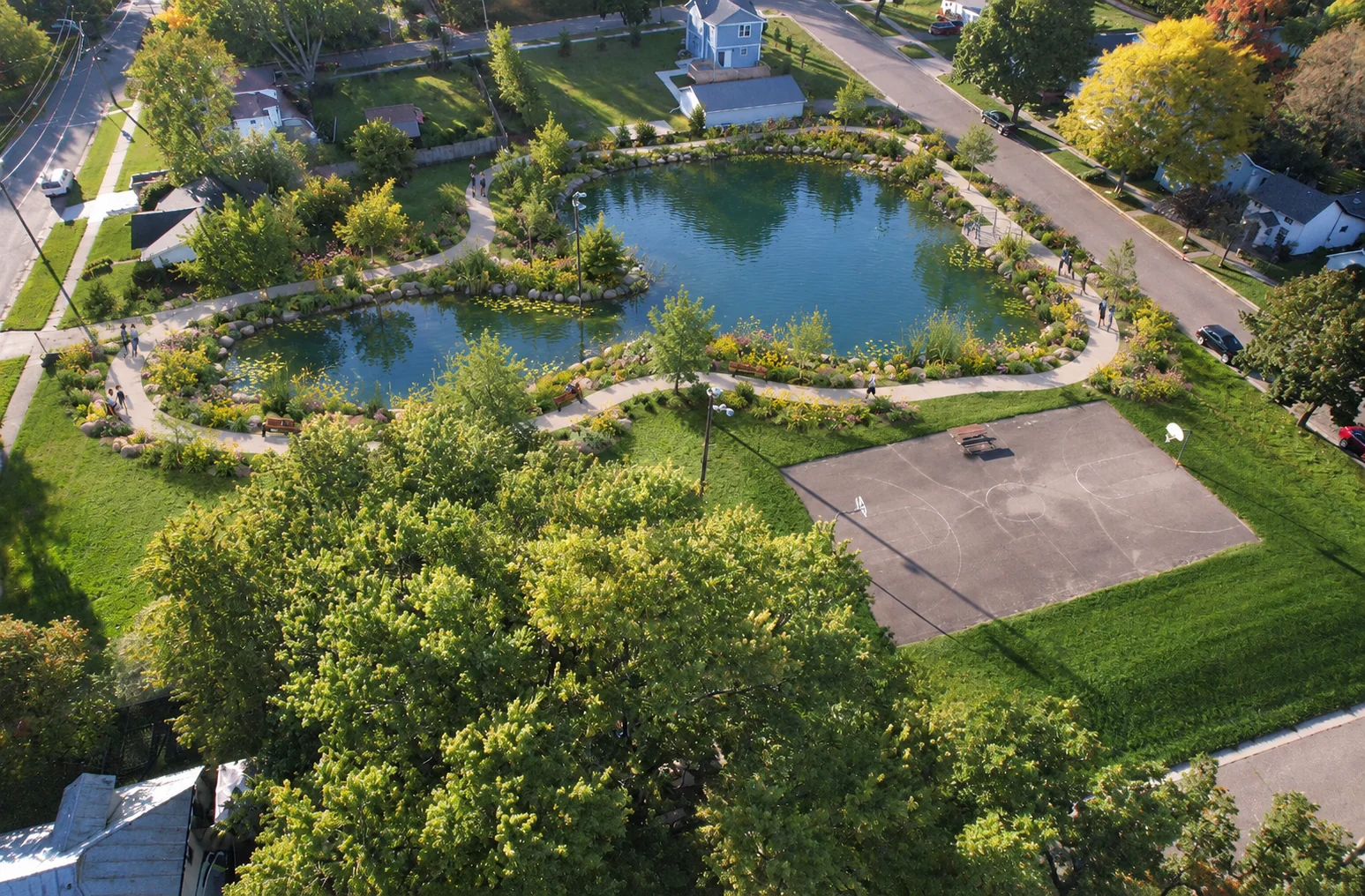 AI-assisted weber pond concept visualization: pond and garden paths beside the basketball court