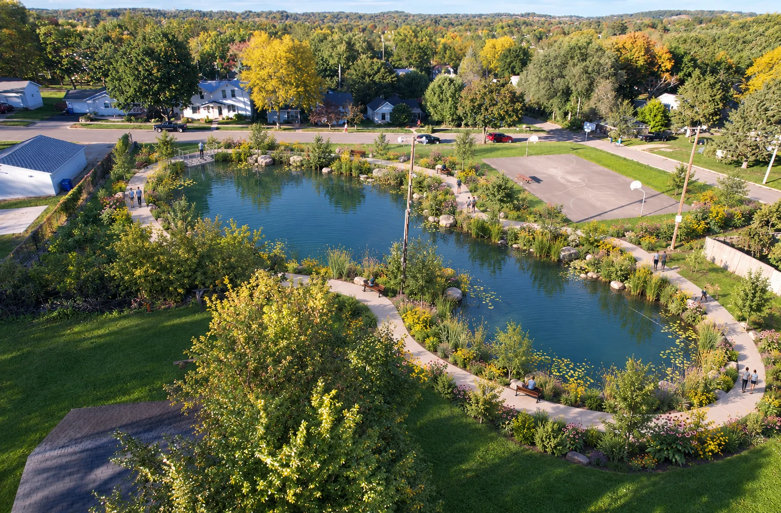 AI-assisted weber pond concept visualization: wide view of pond, paths, and retained basketball court