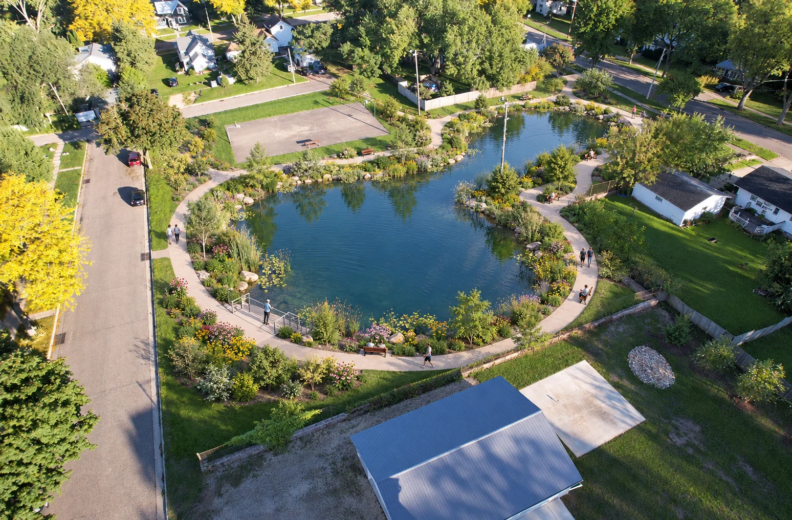 AI-assisted weber pond concept visualization: pond with a walking loop and nearby basketball court